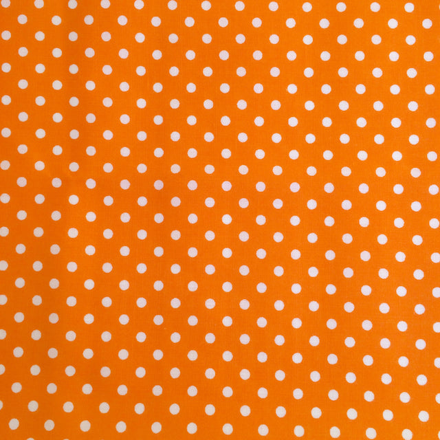 Orange polka dot polycotton fabric