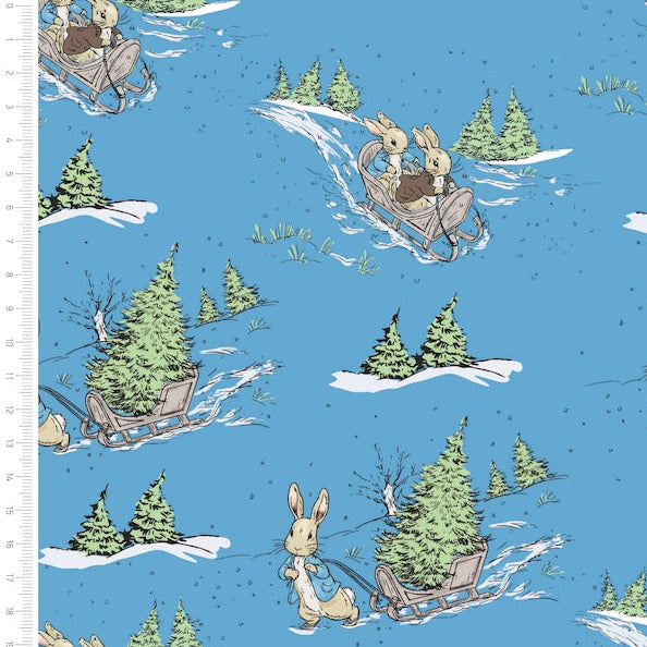 Peter rabbit Christmas fabric, sky blue background with peter rabbit pulling a sledge with a Christmas tree