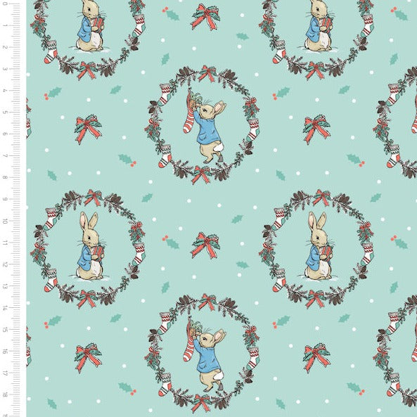 Peter Rabbit Christmas fabric, mint green with Christmas stocking and peter rabbit  in a floral wreath